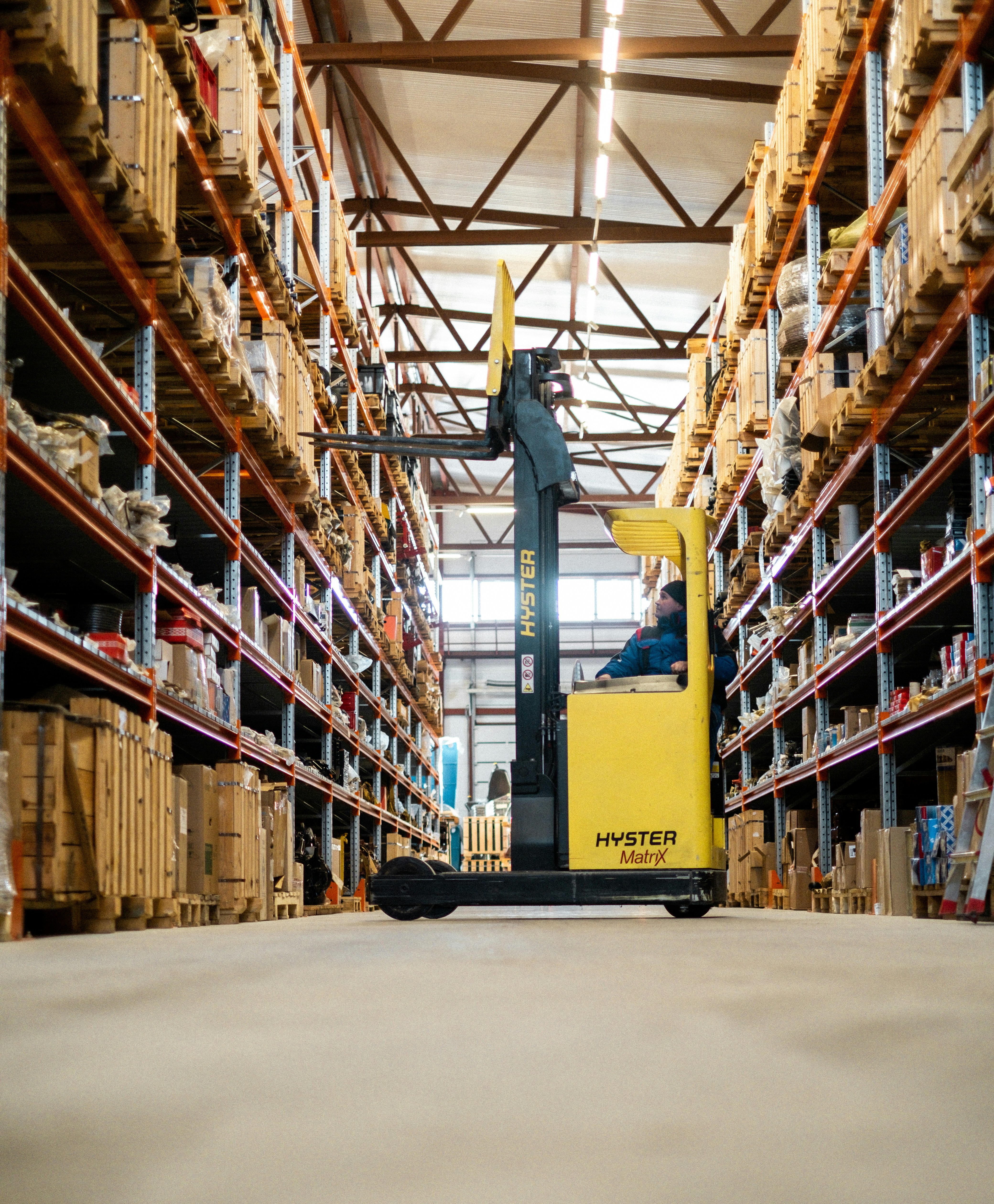 Storeroom with forklift and shelves stocked with supplies